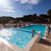 Ampia piscina con persone a bordo vasca.
