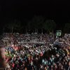 Grande folla in un anfiteatro all'aperto di notte.