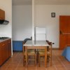 Cucina con tavolo, sedie e divano blu.
